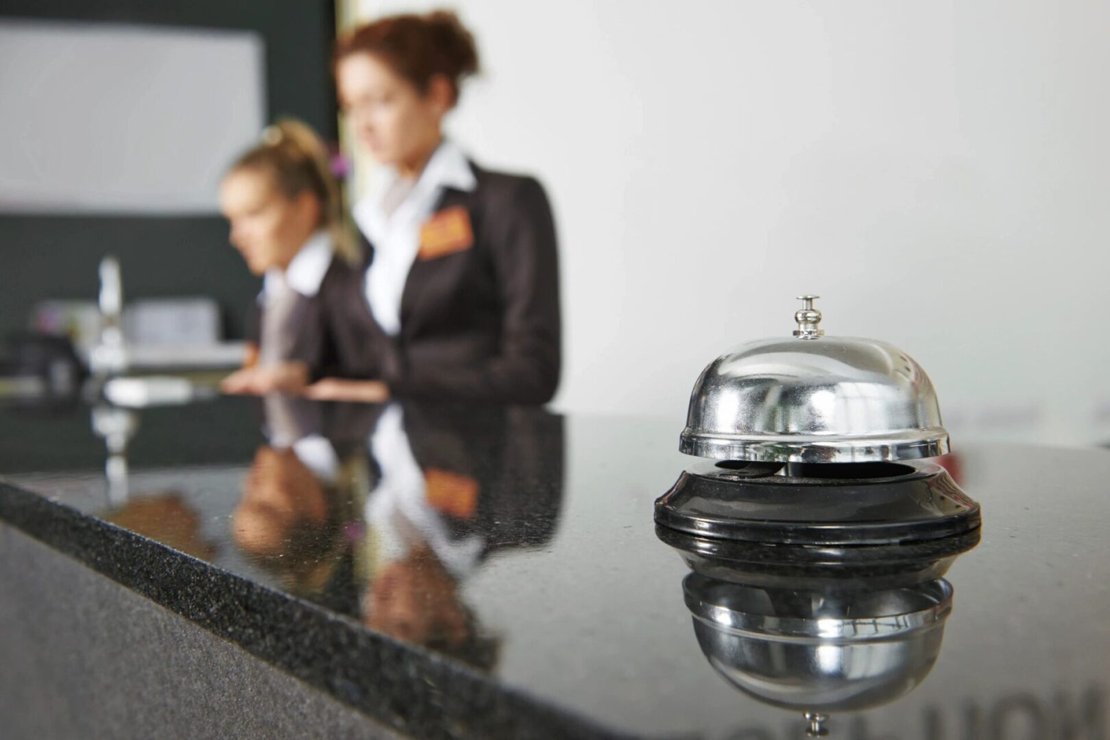 A hotel bell on the counter of a room.